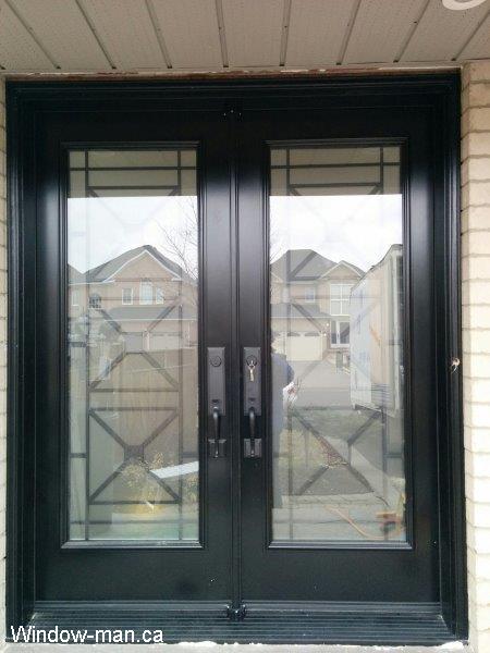 Front door. Double front entry steel insulated. Black. Full wrought iron glass door inserts. Black threshold bottom sill. Century wrought iron glass inserts
